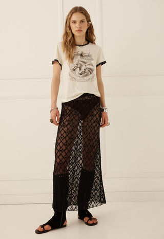  sheer mesh skirt. The room features a blue tufted sofa