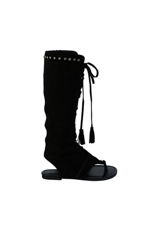 a-black-knee-high-wedge-sandal-boot-with-silver-studs-along-the-top-collar-lace-up-front-details-and-tassel-ties-shown-against-a-plain-white-background