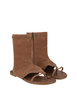 a-pair-of-brown-suede-thong-sandals-with-a-mid-calf-bootie-upper-featuring-brass-tone-metal-studs-along-the-top-edge-and-a-side-zipper